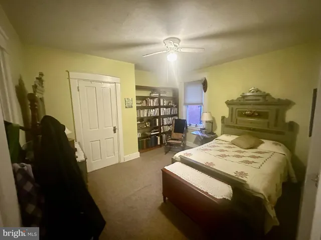 a living room with furniture and a dining table