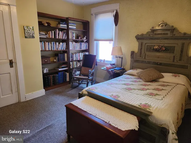 a bedroom with double bed and a window