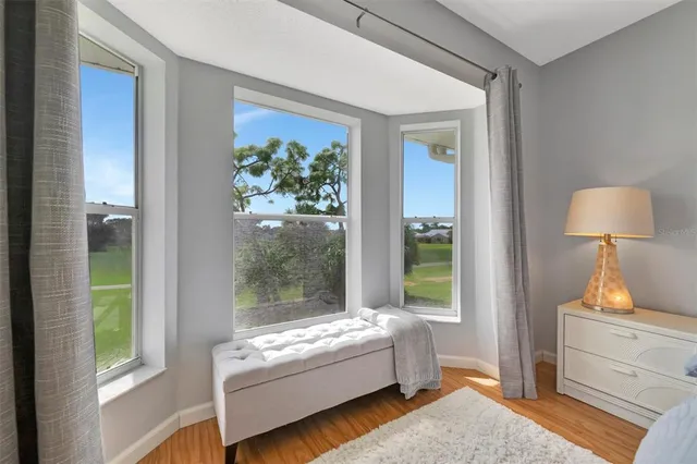 a spacious bedroom with a large bed and a chandelier