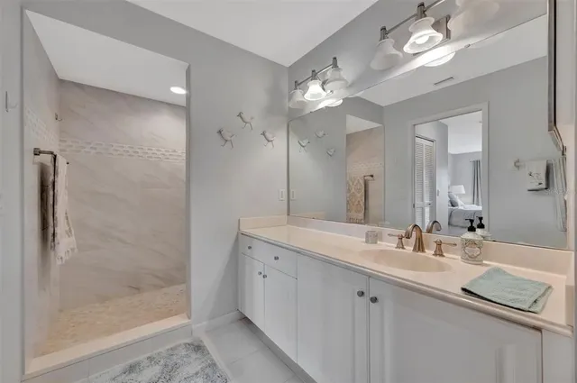 a spacious bathroom with a toilet a sink and a mirror