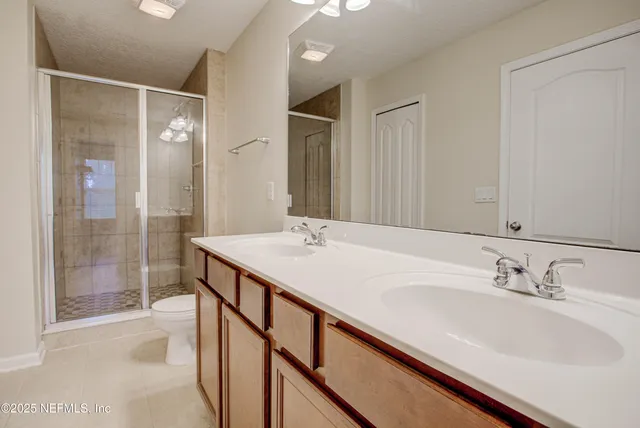 a bathroom with a sink double vanity and a shower