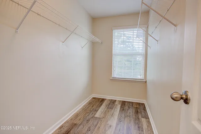 a view of a room with rack on the wall and a window
