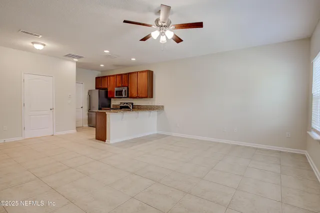 a view of kitchen with microwave and cabinets