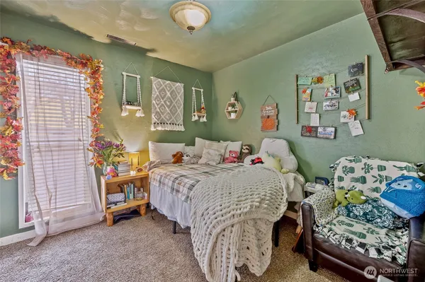 a bedroom with a bed and a window