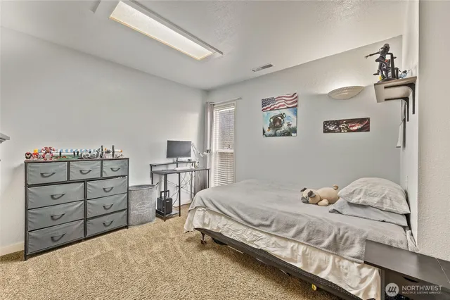 a bedroom with a bed and a bookshelf