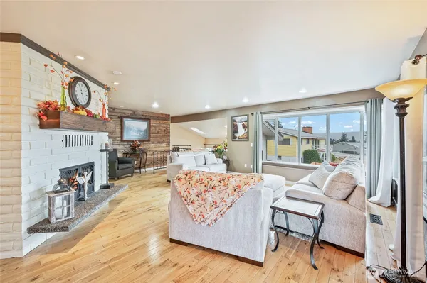 a living room with fireplace furniture and a fireplace