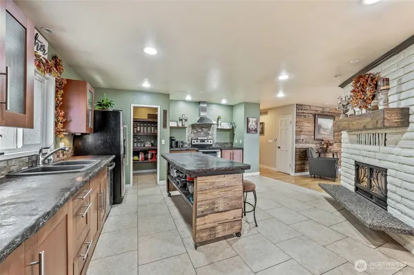 a kitchen with stainless steel appliances granite countertop a sink counter space and cabinets