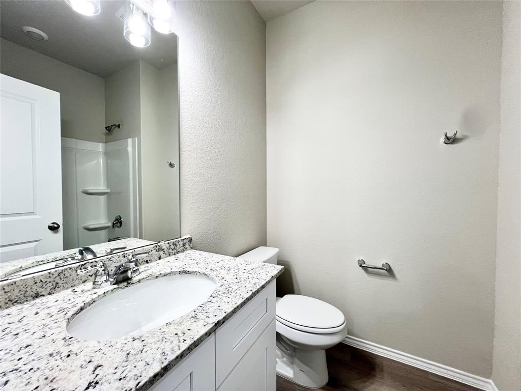 3501 East Renfro Street, Unit 201 Burleson, TX 76028 - Photo 26 of 33 a bathroom with a sink and a toilet