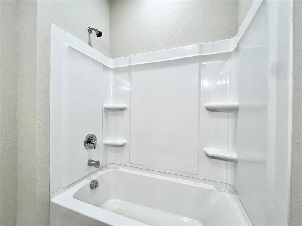 3501 East Renfro Street, Unit 201 Burleson, TX 76028 - Photo 28 of 33 a bathroom with a tub and a shower