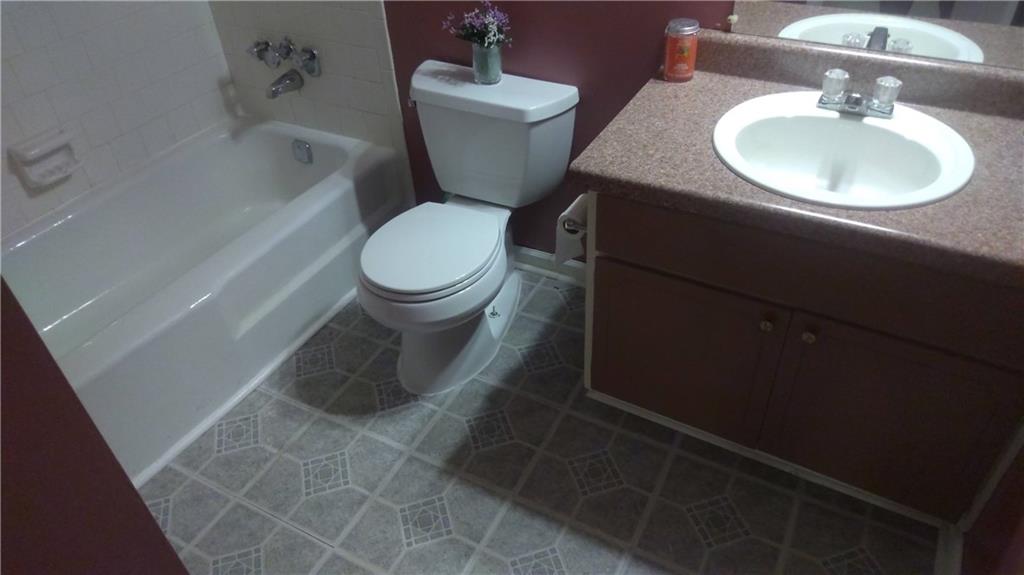 4701 Flat Shoals Road Union City, GA 30291 - Photo 13 of 23 a bathroom with a sink toilet and a mirror