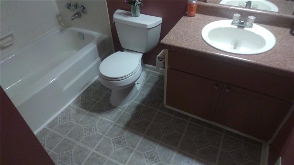 4701 Flat Shoals Road Union City, GA 30291 - Photo 18 of 23 a bathroom with a sink toilet and a mirror
