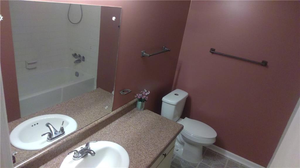 4701 Flat Shoals Road Union City, GA 30291 - Photo 21 of 23 a bathroom with a granite countertop toilet and sink