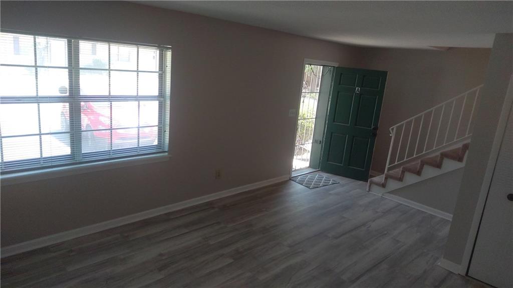 4701 Flat Shoals Road Union City, GA 30291 - Photo 23 of 23 an empty room with wooden floor and windows