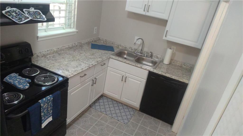 4701 Flat Shoals Road Union City, GA 30291 - Photo 3 of 23 a kitchen with a sink stove and cabinets