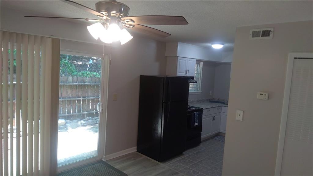 4701 Flat Shoals Road Union City, GA 30291 - Photo 5 of 23 a view of hallway with window and a refrigerator