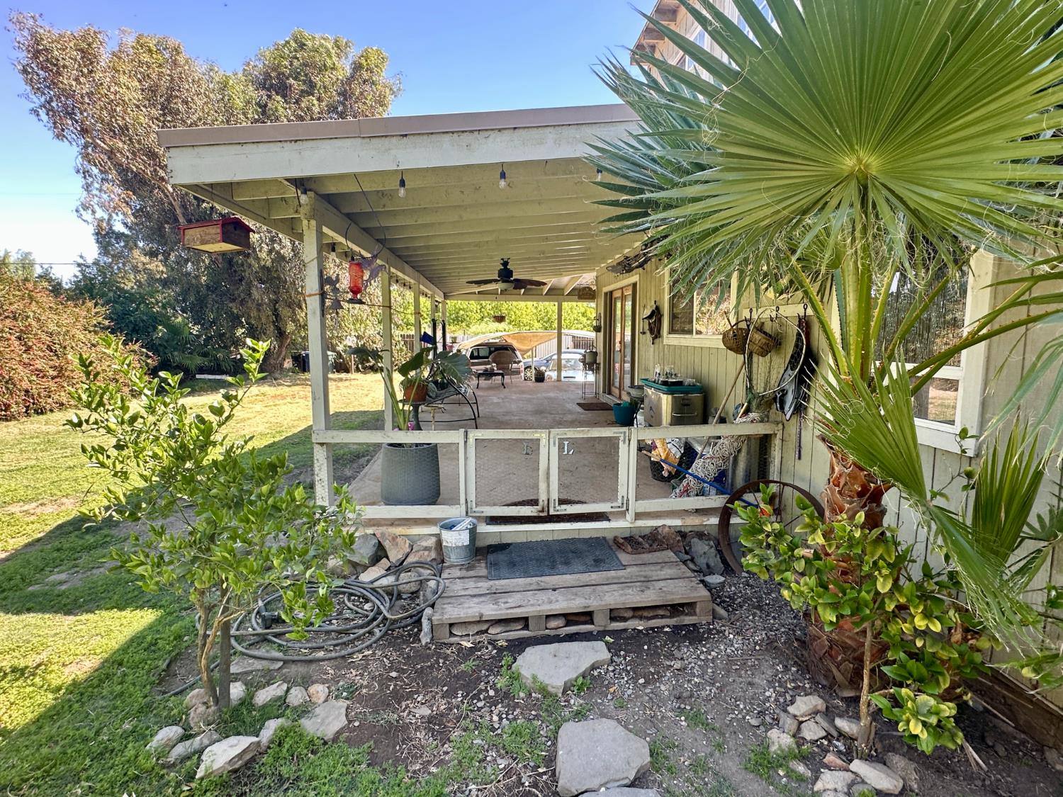 777 West Brannan Island Road Isleton, CA 95641 - Photo 8 of 24 a view of a patio with table and chairs potted plants and large tree