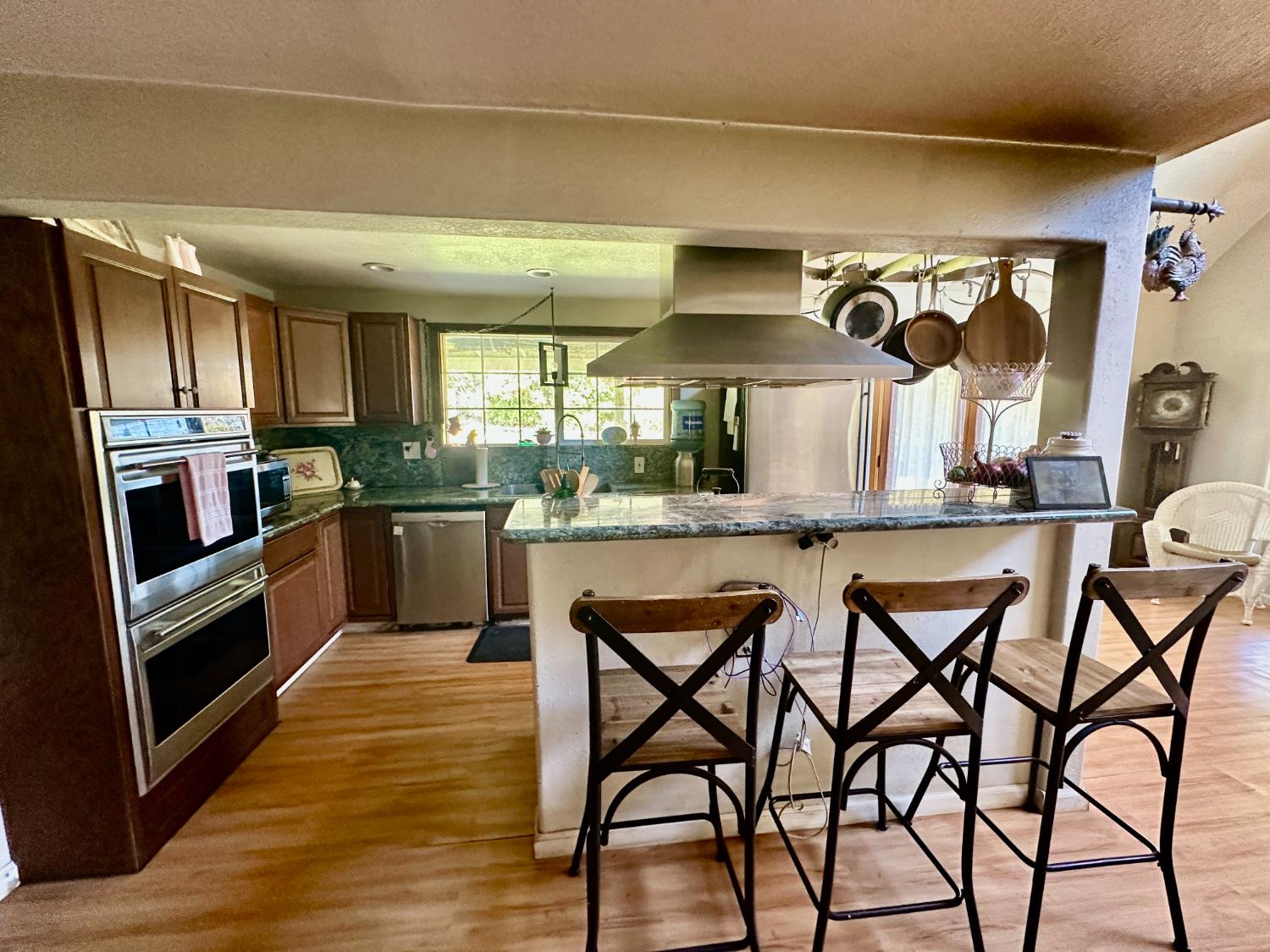 777 West Brannan Island Road Isleton, CA 95641 - Photo 9 of 24 a kitchen with stainless steel appliances granite countertop a kitchen island stools a stove a sink and a refrigerator