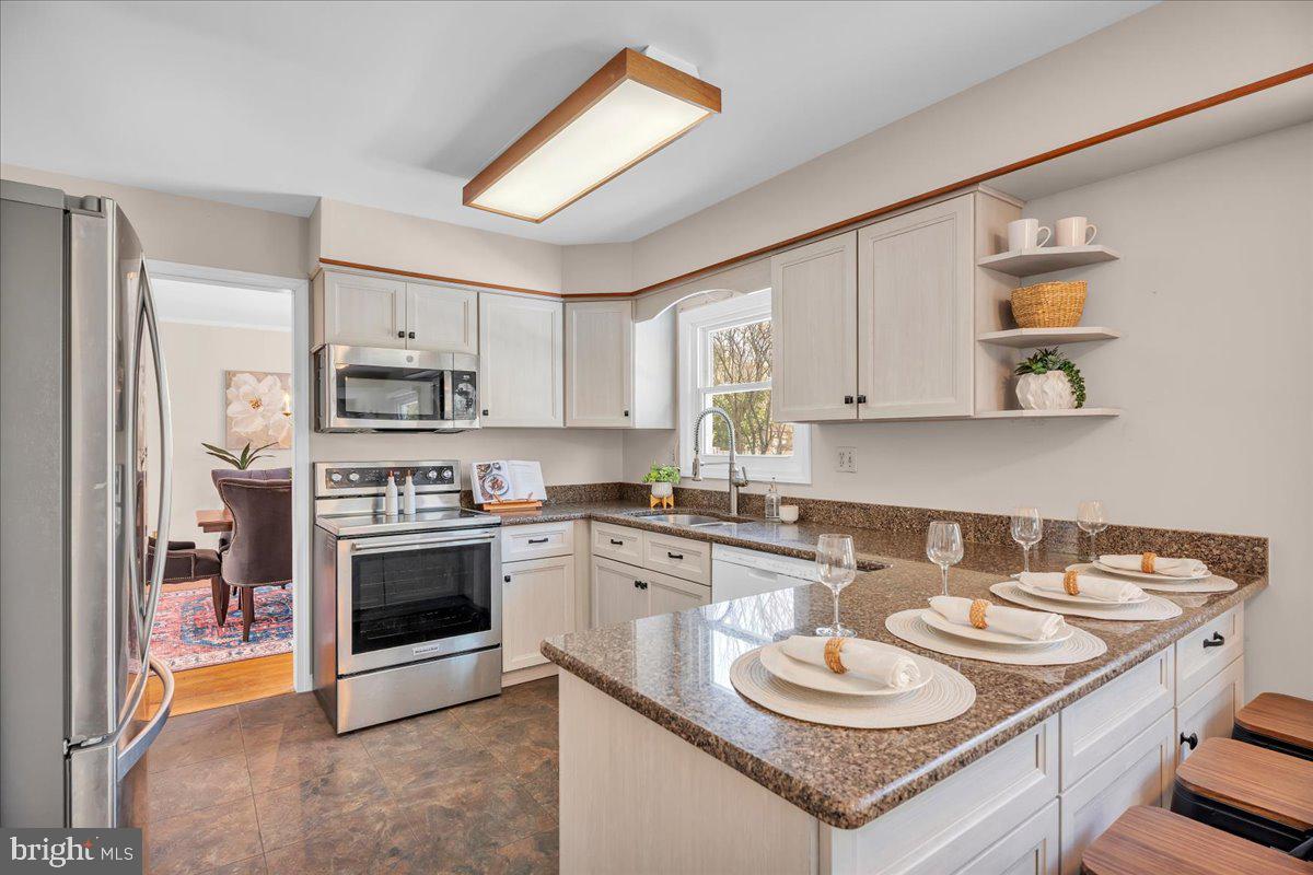 517 Perry Drive Mount Laurel, NJ 08054 - Photo 7 of 41 a kitchen with stainless steel appliances granite countertop a sink stove and cabinets