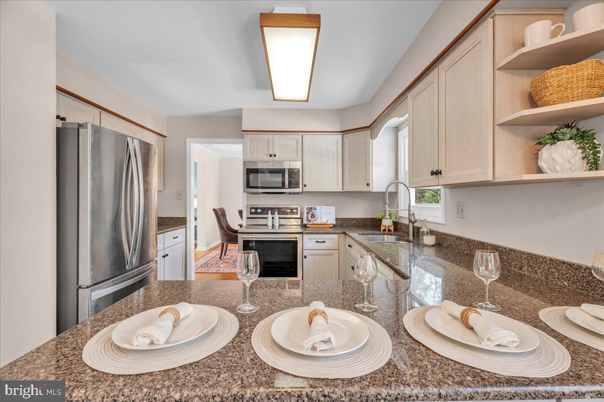 517 Perry Drive Mount Laurel, NJ 08054 - Photo 8 of 41 a kitchen with stainless steel appliances a dining table and chairs