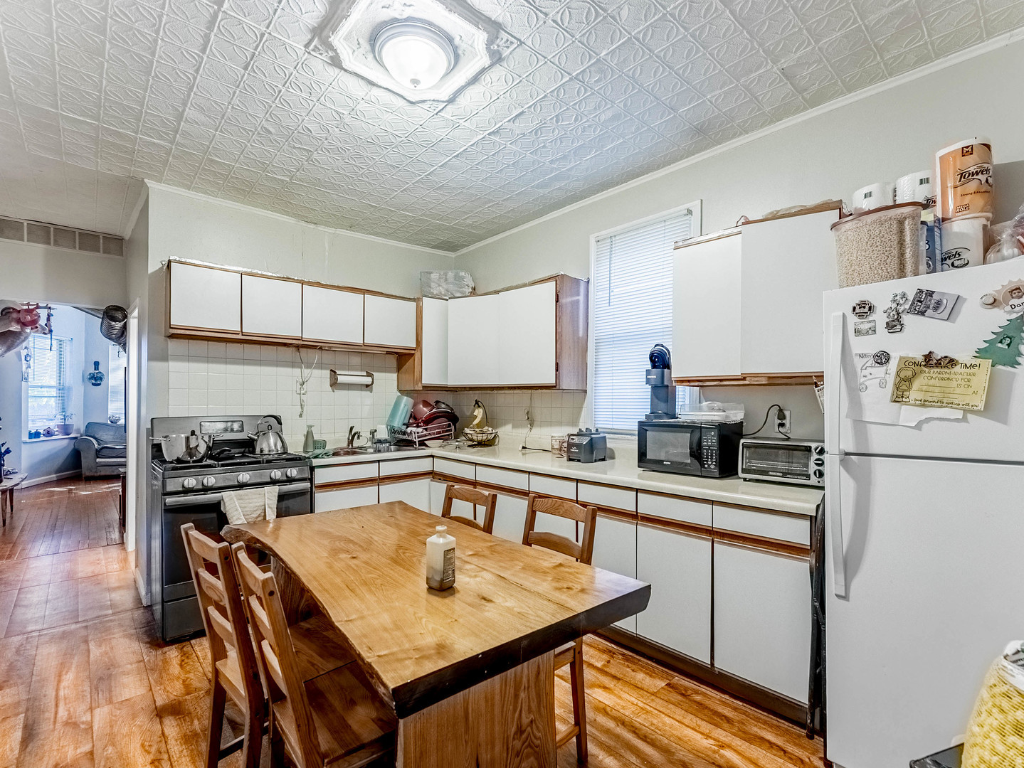 3244 North Drake Avenue Chicago, IL 60618 - Photo 20 of 37 a kitchen with granite countertop stainless steel appliances a stove a sink dishwasher and white cabinets with wooden floor