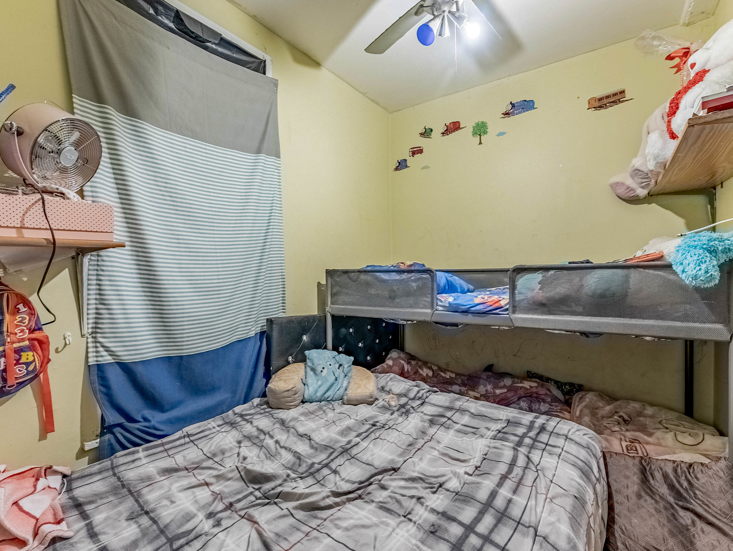 3244 North Drake Avenue Chicago, IL 60618 - Photo 27 of 37 a bed sitting in a bedroom next to a lamp