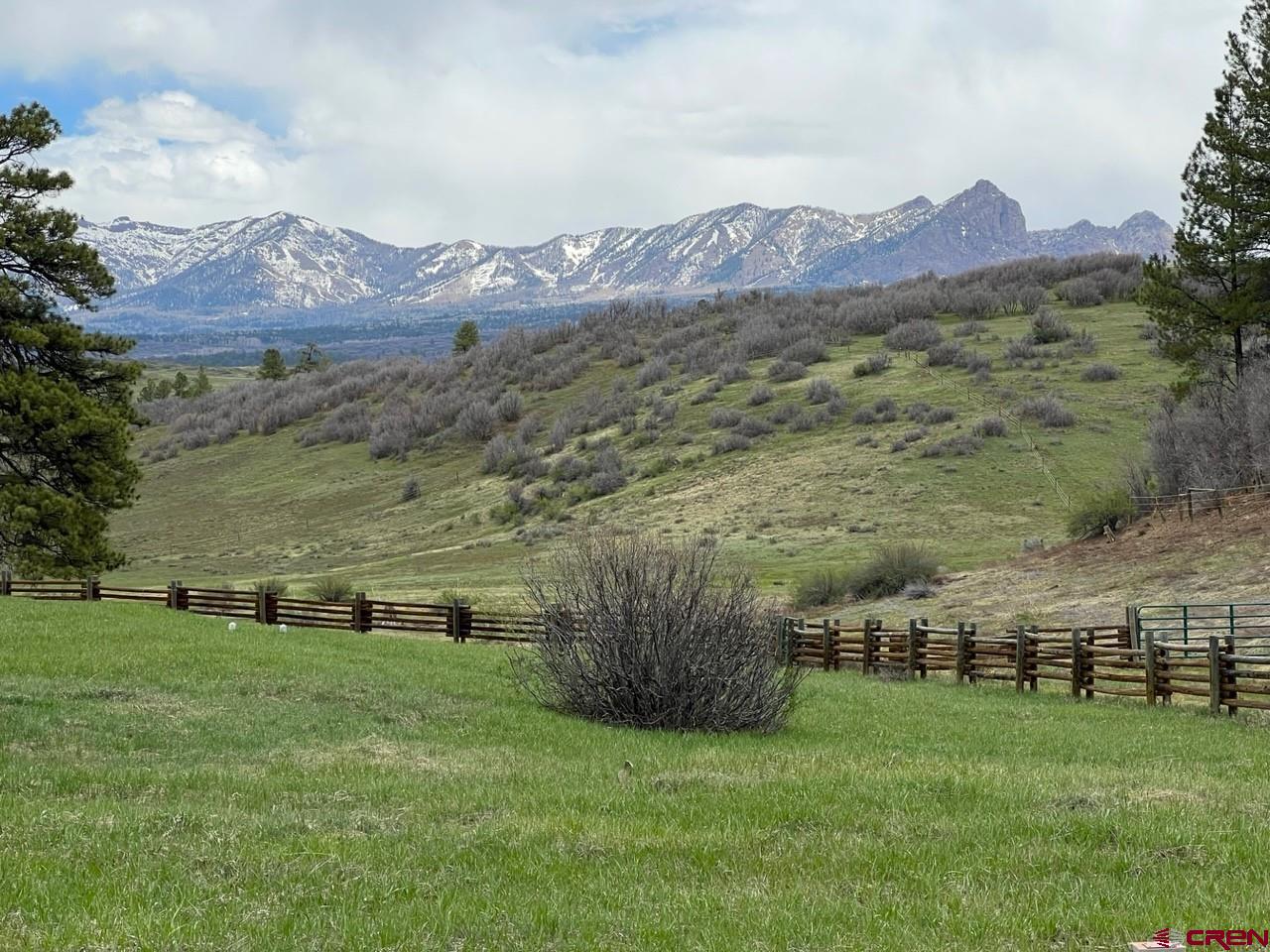 Lot 2 Spring Valley Ranch Road Chromo, CO 81128 - Photo 18 of 35 a view of a lush green hillside and houses with a yard