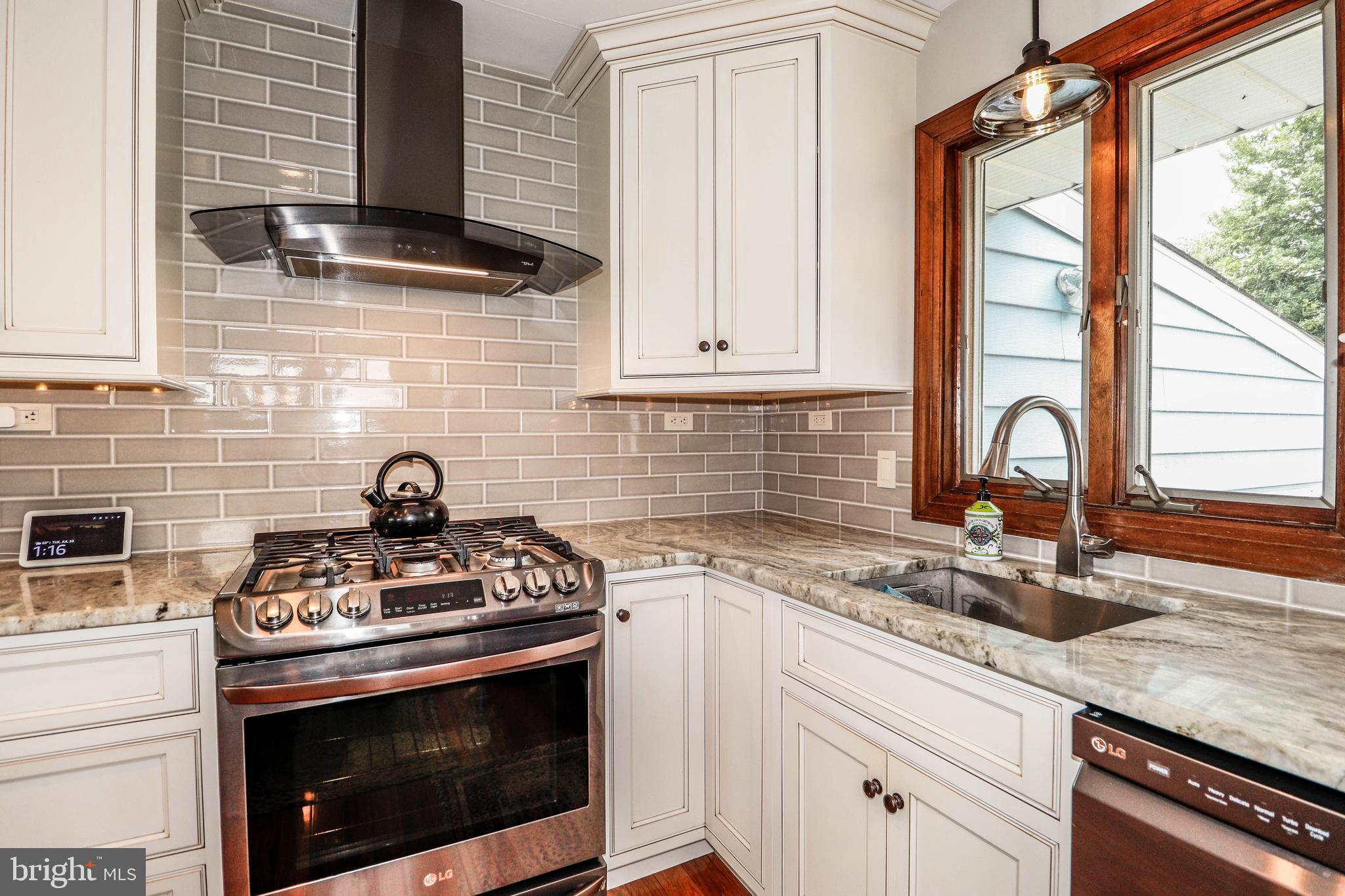 94 Winding Way Hamilton, NJ 08620 - Photo 11 of 38 a kitchen with granite countertop a sink stainless steel appliances and cabinets