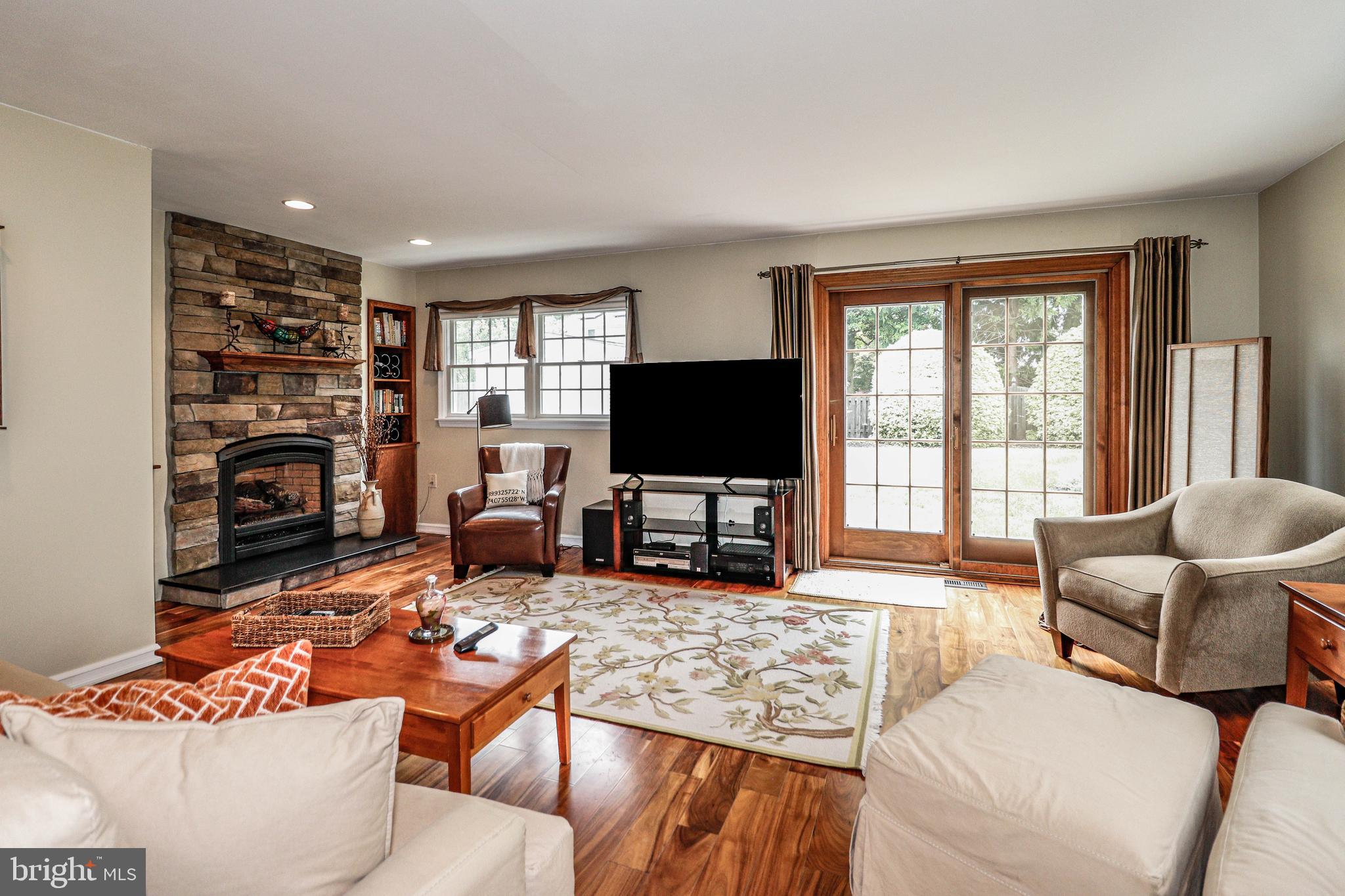 94 Winding Way Hamilton, NJ 08620 - Photo 19 of 38 a living room with furniture large window and a flat screen tv