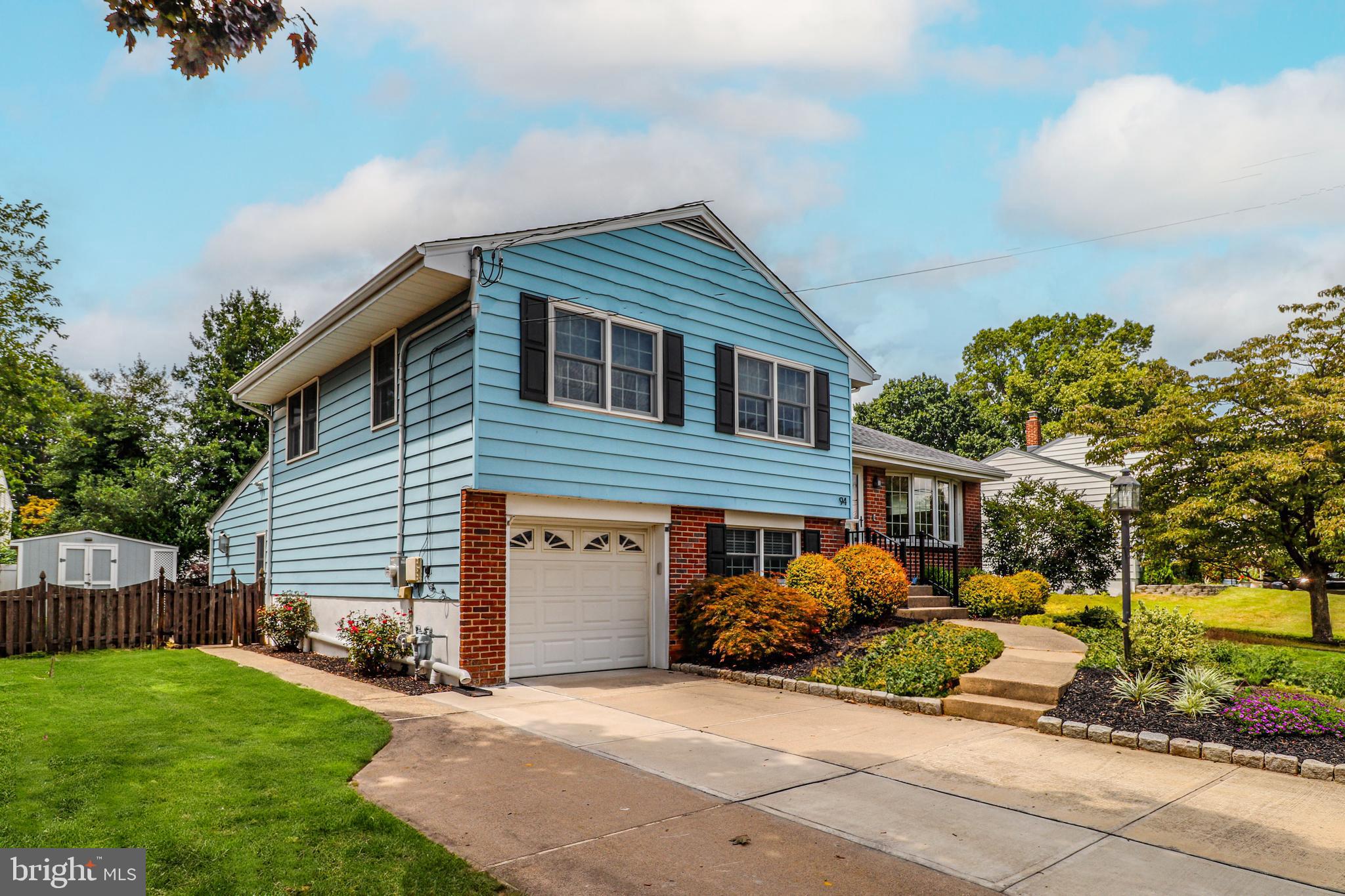 94 Winding Way Hamilton, NJ 08620 - Photo 2 of 38 a front view of a house with a yard and garage