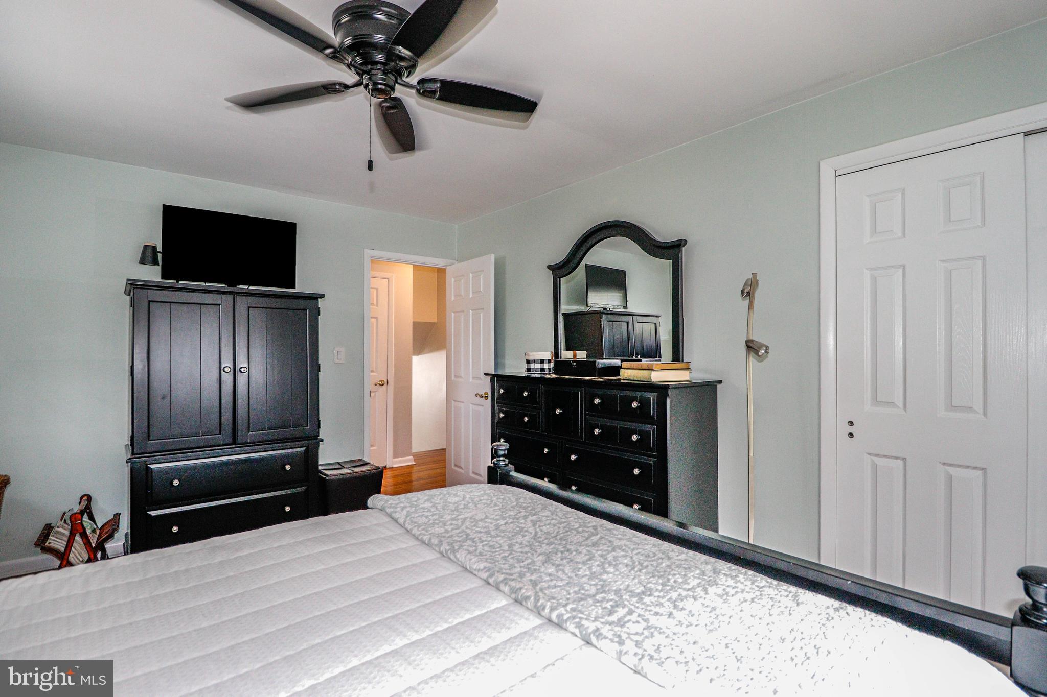 94 Winding Way Hamilton, NJ 08620 - Photo 26 of 38 a bedroom with a bed and a flat screen tv