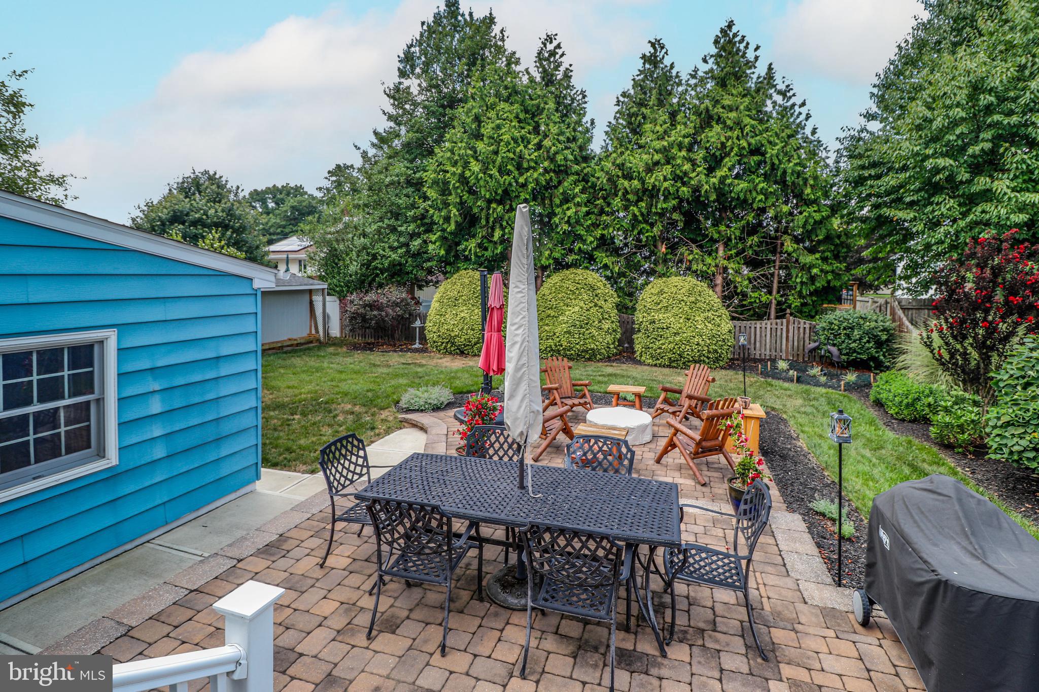 94 Winding Way Hamilton, NJ 08620 - Photo 36 of 38 a view of a patio with table and chairs and potted plants with wooden fence