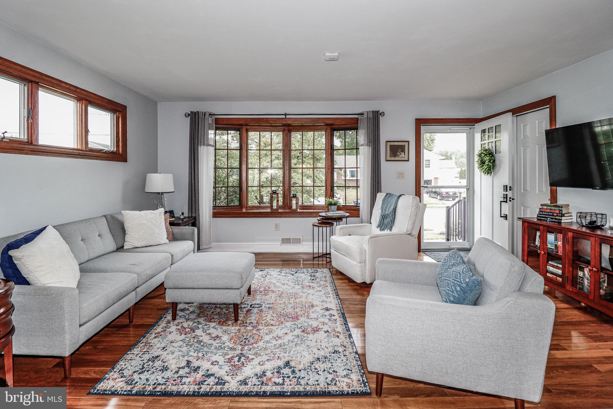 94 Winding Way Hamilton, NJ 08620 - Photo 7 of 38 a living room with fireplace furniture and a flat screen tv