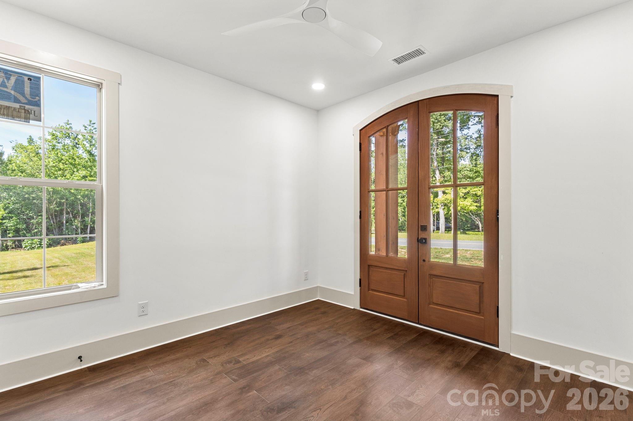 1167 Tirzah Road Rock Hill, SC 29732 - Photo 16 of 25 an empty room with wooden floor and windows