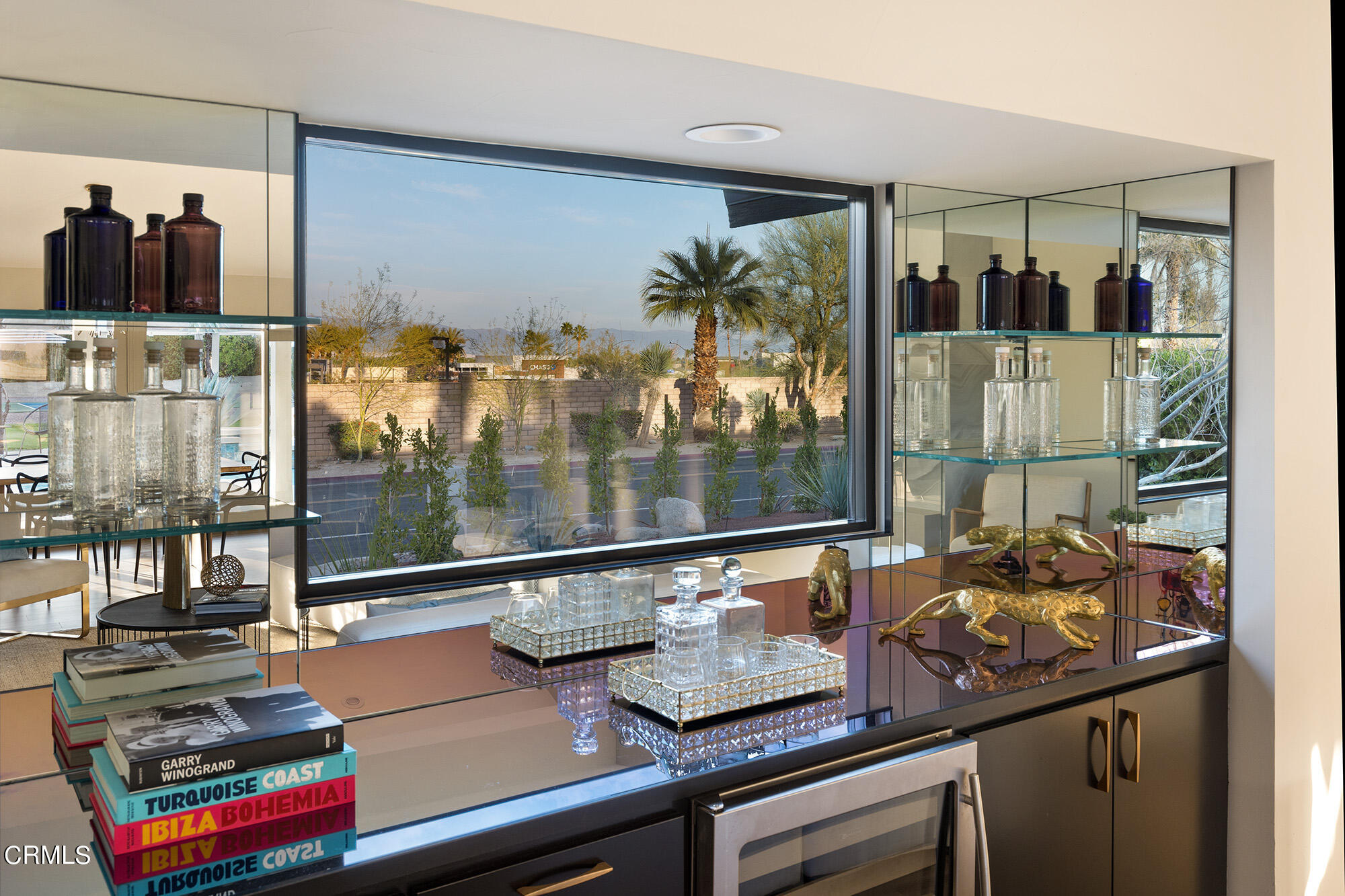 71817 Sahara Road Rancho Mirage, CA 92270 - Photo 5 of 25 a room with lots of different furniture and a floor to ceiling window