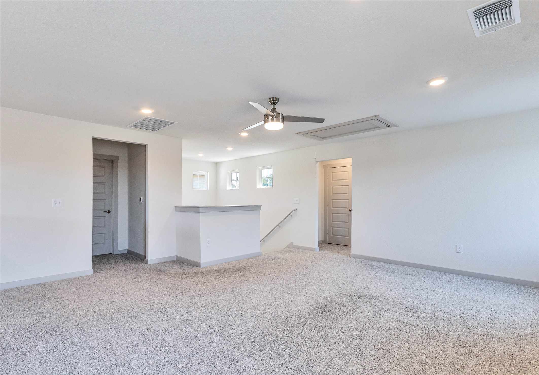 10508 Defender Trail Austin, TX 78754 - Photo 24 of 28 A spacious secondary living area features soft carpeting, recessed lighting, and a ceiling fan for year-round comfort.