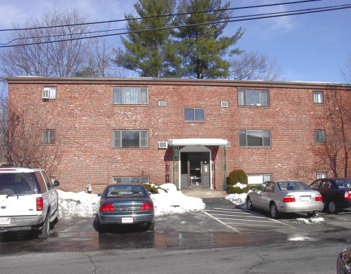 a front view of a building with parking