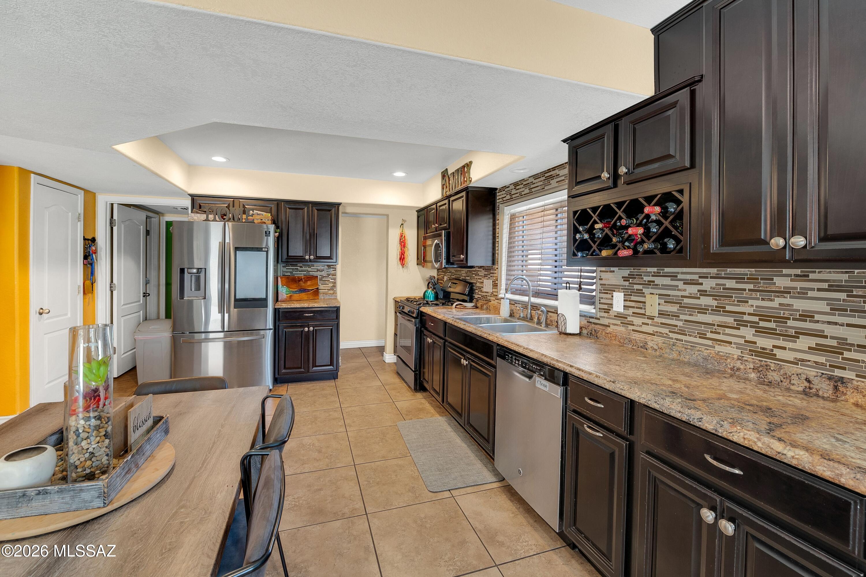 7159 West Maple Ridge Drive Tucson, AZ 85743 - Photo 12 of 42 a large kitchen with stainless steel appliances granite countertop a sink counter space and cabinets