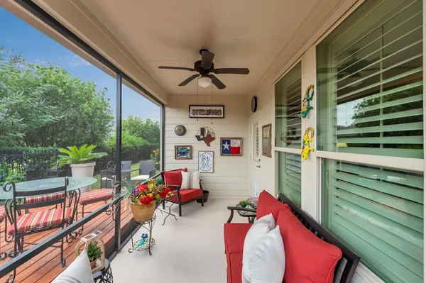 a living room with furniture and a floor to ceiling window
