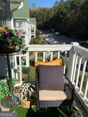 a view of a patio with a table chairs and a potted plant