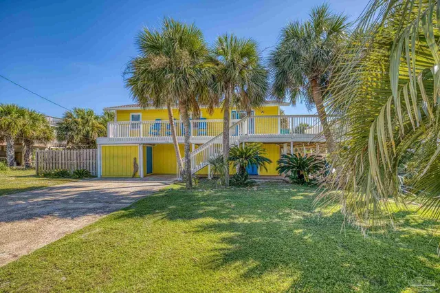 a view of a house with a yard and tree s