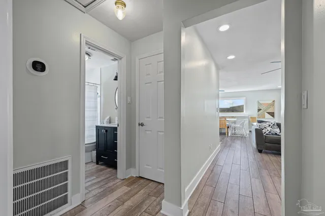 a view of an entryway with wooden floor and windows