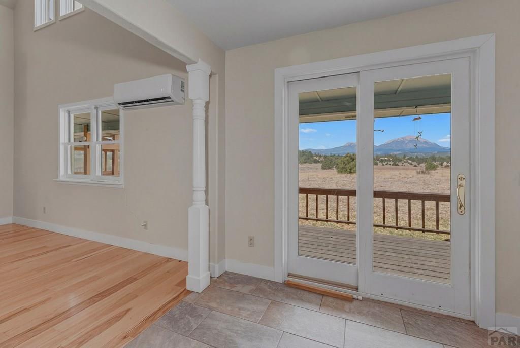 23360 Monarch Road Aguilar, CO 81020 - Photo 16 of 52 a view of an empty room with wooden floor and a window