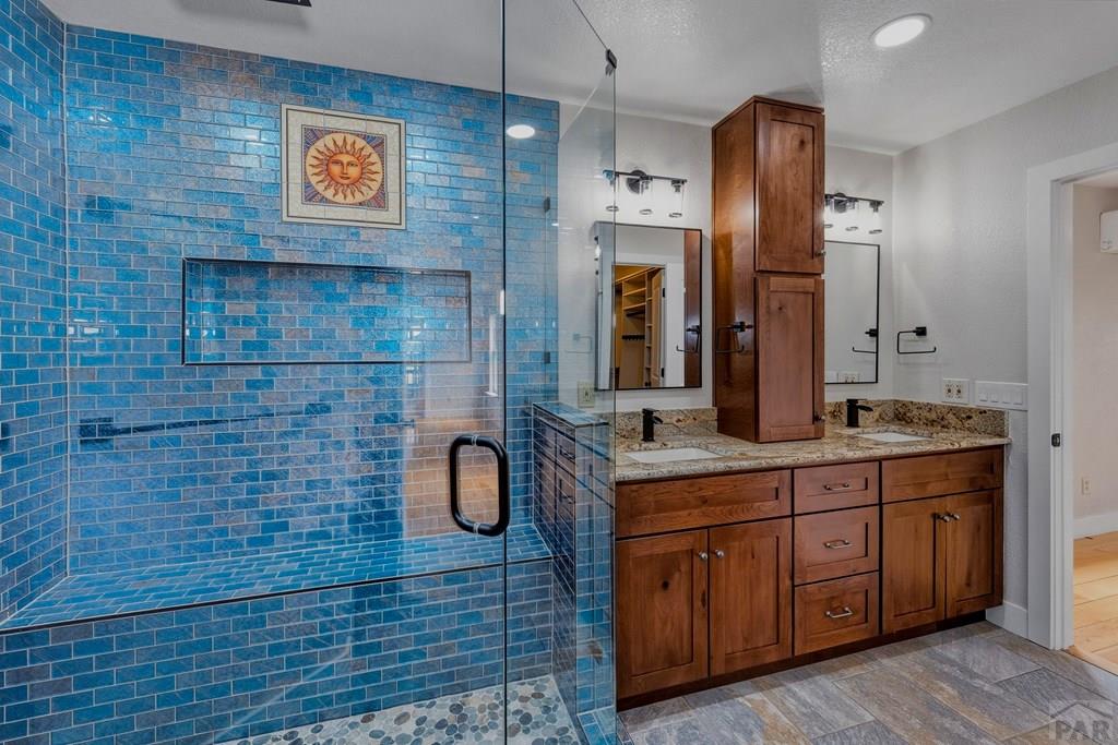 23360 Monarch Road Aguilar, CO 81020 - Photo 19 of 52 a bathroom with a sink a double vanity and a shower