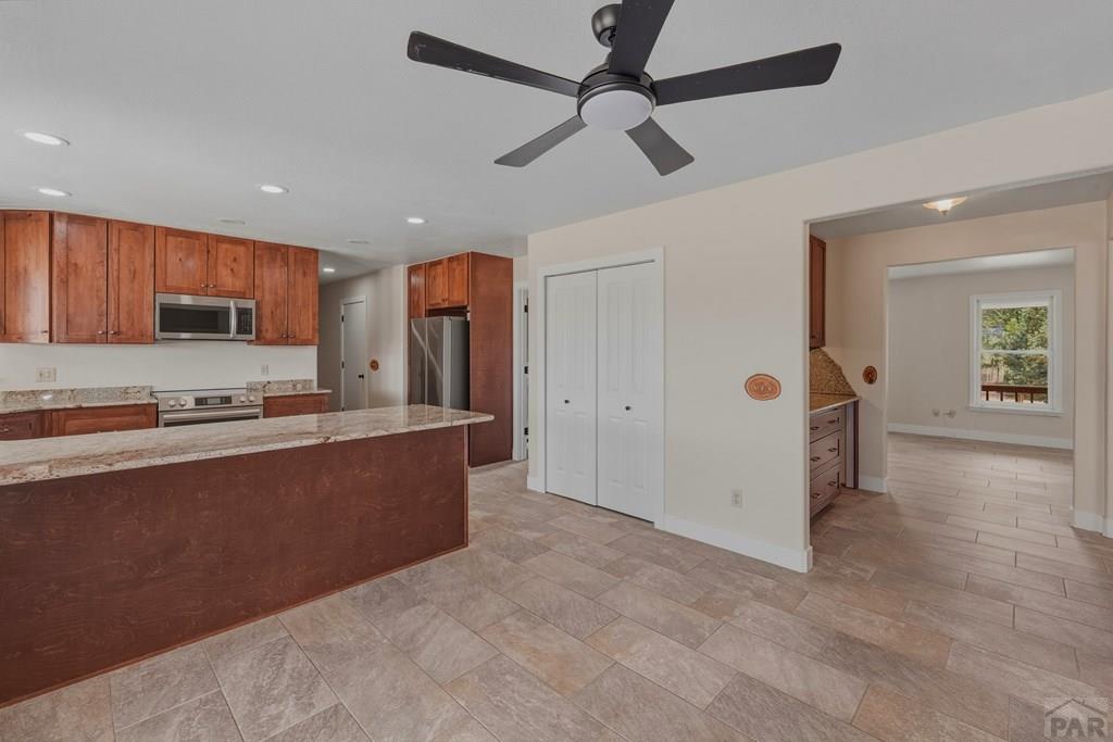 23360 Monarch Road Aguilar, CO 81020 - Photo 2 of 52 a large kitchen with stainless steel appliances granite countertop a refrigerator and a stove top oven