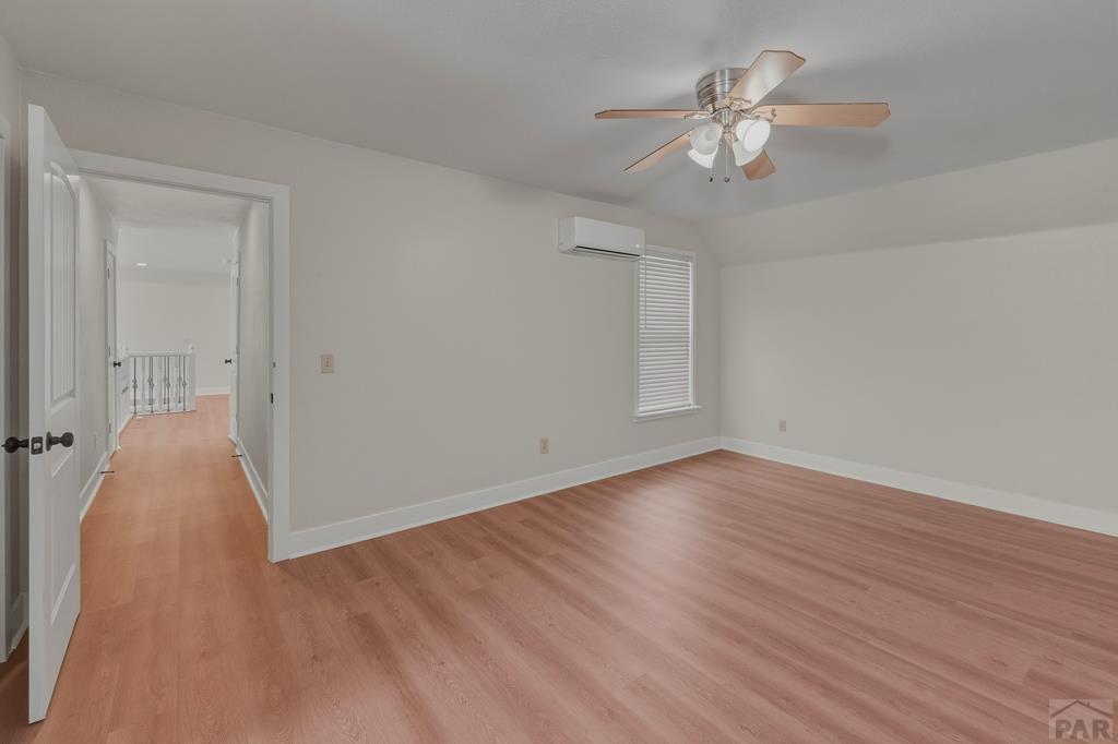 23360 Monarch Road Aguilar, CO 81020 - Photo 25 of 52 wooden floor in an empty room with a chandelier fan