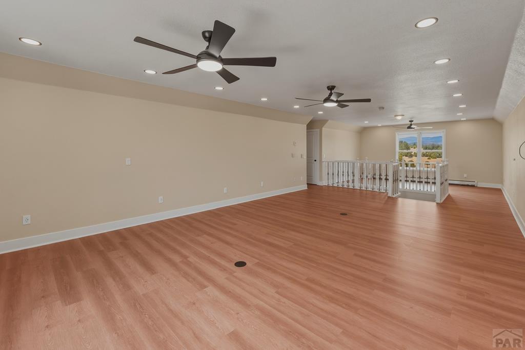 23360 Monarch Road Aguilar, CO 81020 - Photo 32 of 52 an empty room with wooden floor and a ceiling fan