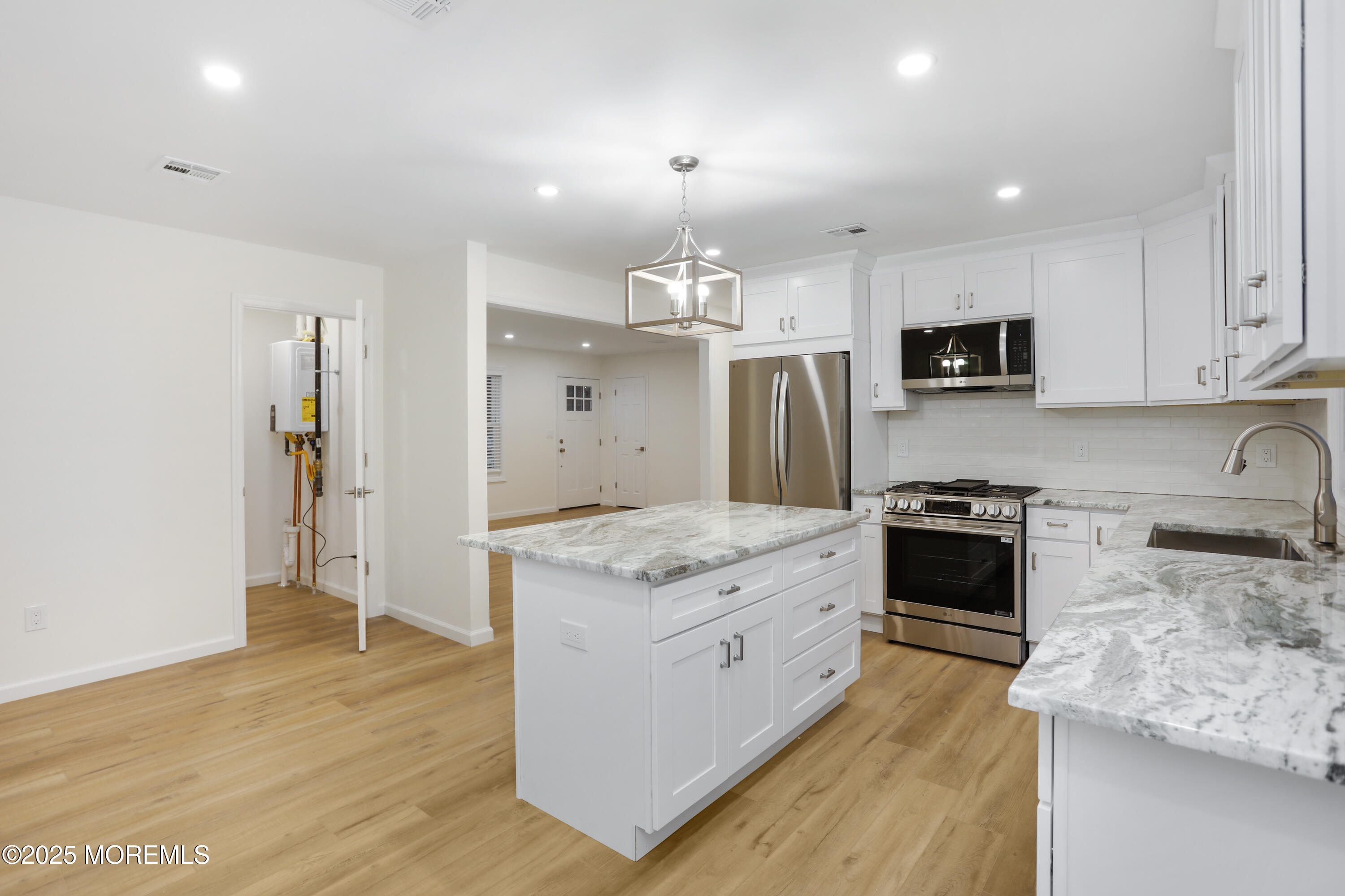 2401 Mallow Street Point Pleasant, NJ 08742 - Photo 14 of 20 a kitchen with stainless steel appliances granite countertop a stove top oven a sink a refrigerator and a granite counter tops