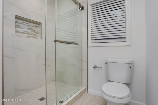 a white toilet sitting next to a bathroom sink
