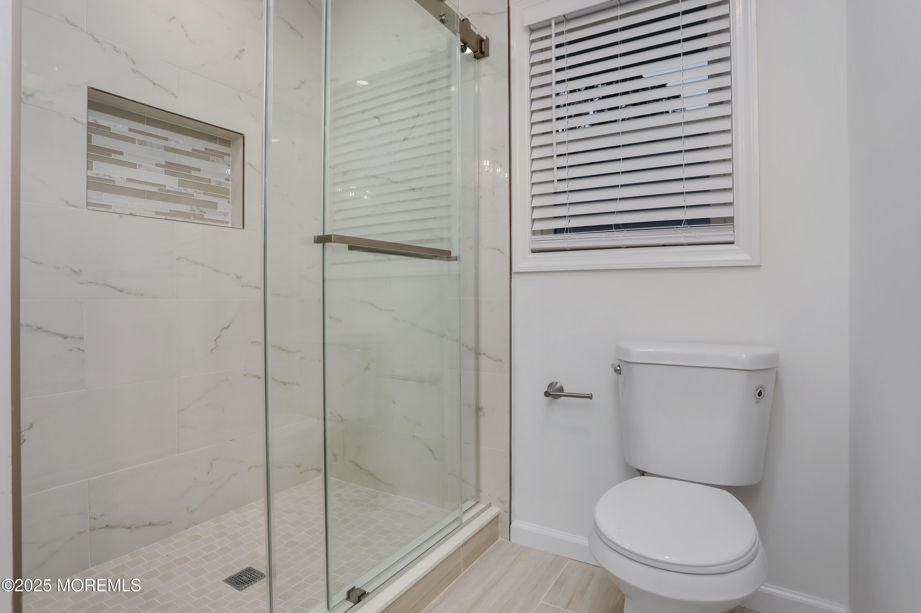 2401 Mallow Street Point Pleasant, NJ 08742 - Photo 20 of 20 a white toilet sitting next to a bathroom sink