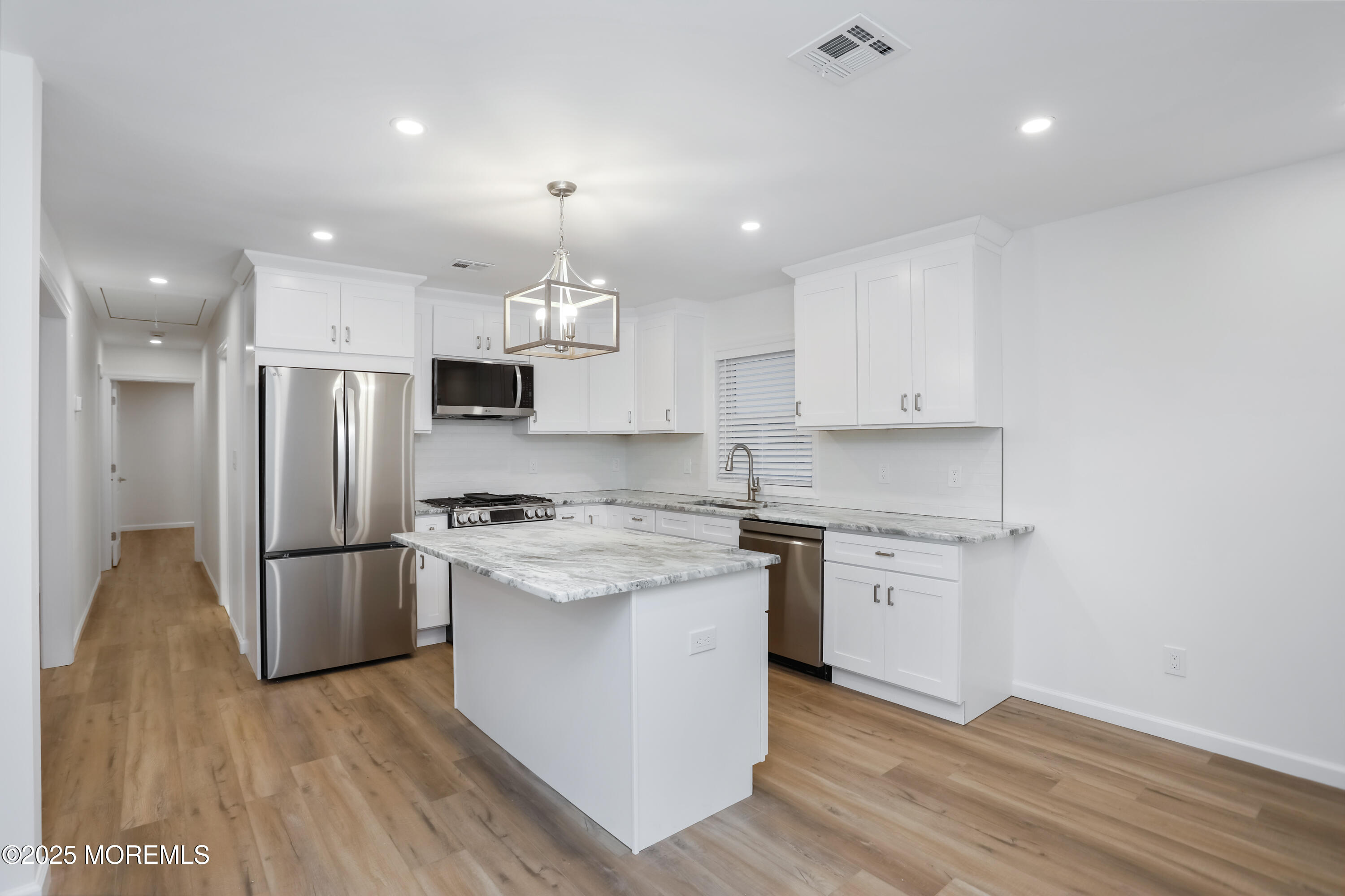 2401 Mallow Street Point Pleasant, NJ 08742 - Photo 7 of 20 a kitchen with a stove a refrigerator and a sink